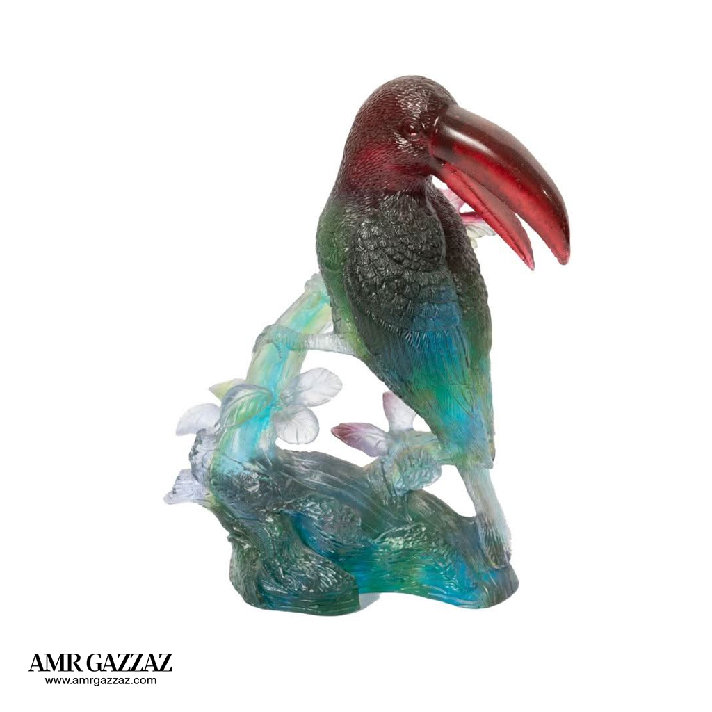A PATE-DE-VERRE GLASS TUCAN   SCULPTURE