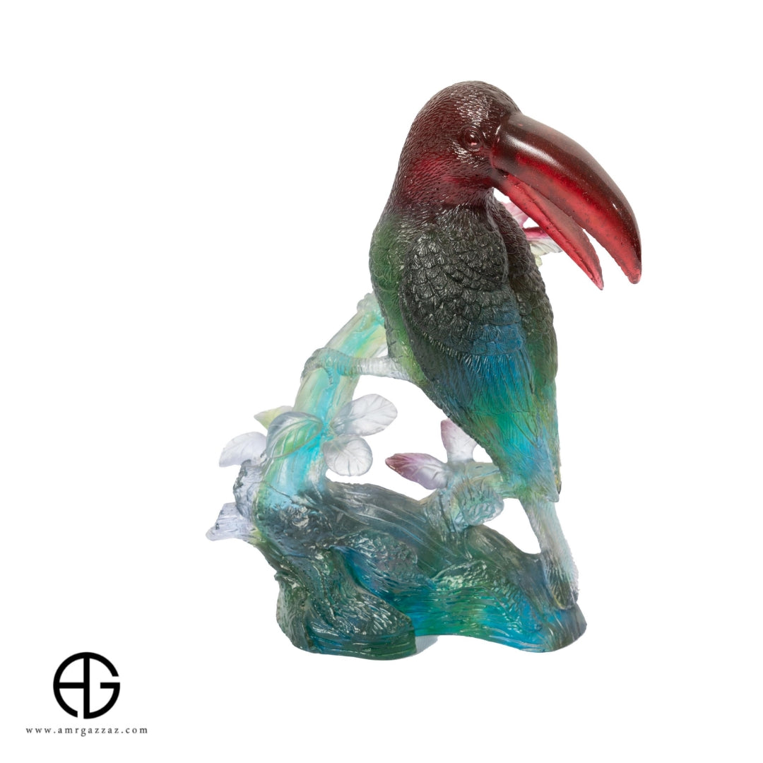 A PATE-DE-VERRE GLASS TUCAN   SCULPTURE