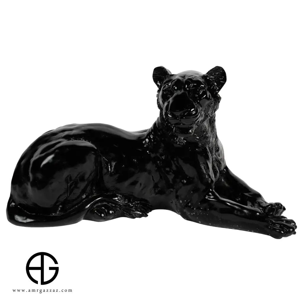 A PATE-DE-VERRE GLASS LYING LEOPARD