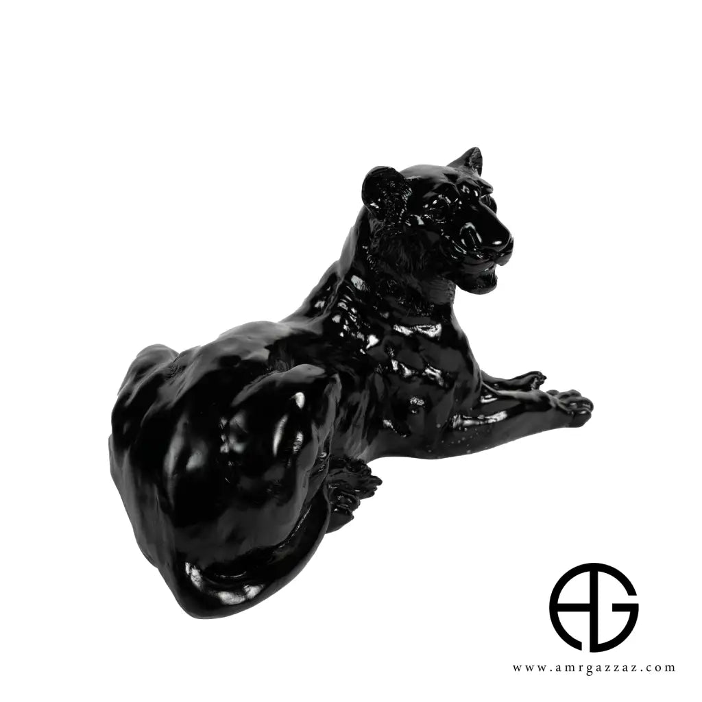 A PATE-DE-VERRE GLASS LYING LEOPARD