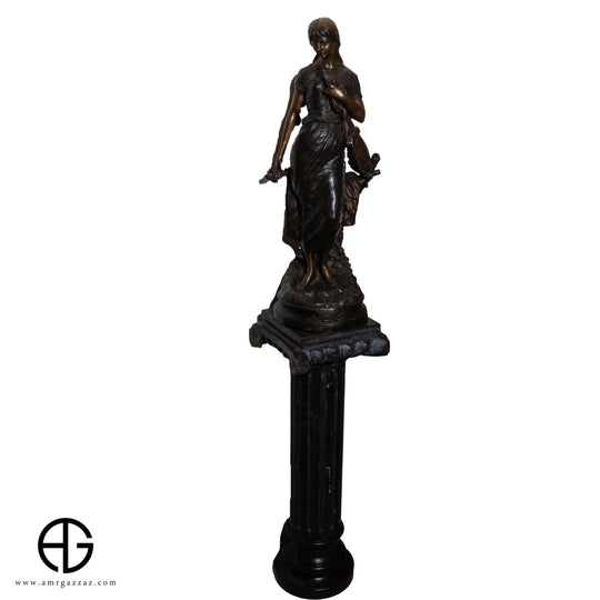 A girl from the Roman era Beautiful classic Italian bronze statue of a young girl from the Roman era on a marble column
