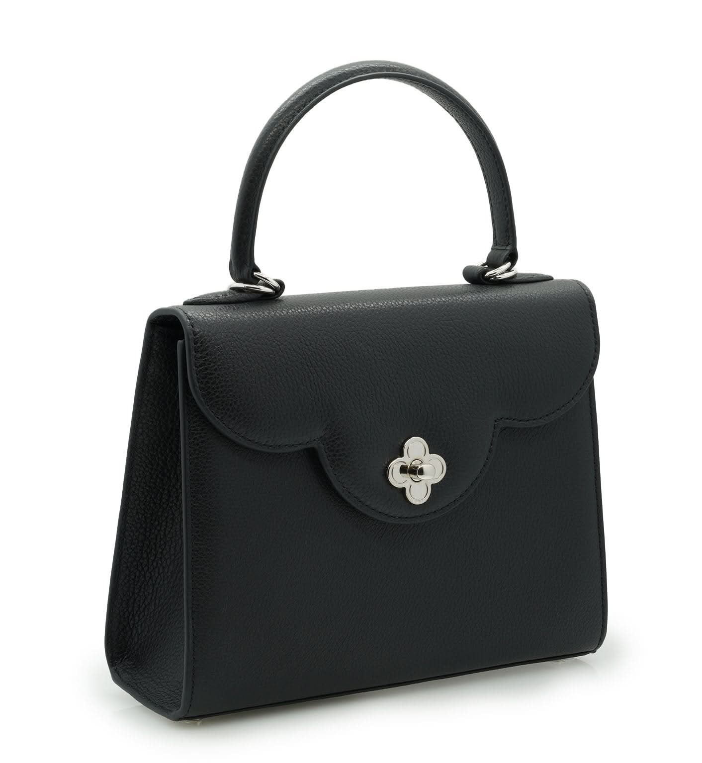 حقيبة يد جلدية سوداء مزخرفة على شكل زهرة للسيدة الأولى