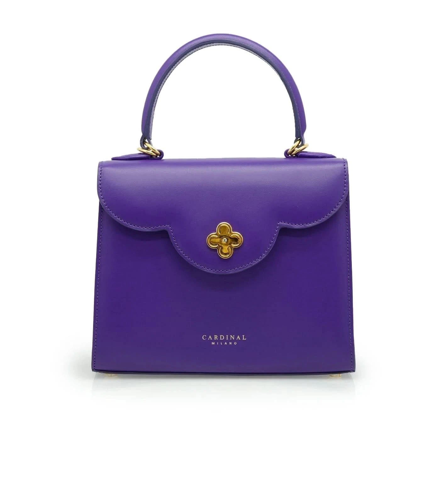 حقيبة يد جلدية أرجوانية اللون من تصميم السيدة الأولى