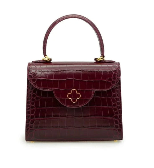 حقيبة يد جلدية منقوش عليها جلد التمساح باللون العنابي للسيدة الأولى