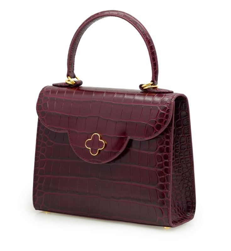 حقيبة يد جلدية منقوش عليها جلد التمساح باللون العنابي للسيدة الأولى