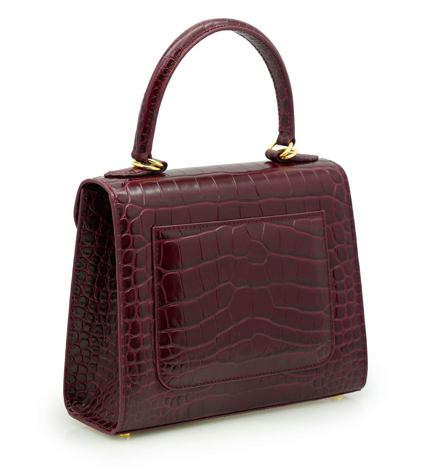حقيبة يد جلدية منقوش عليها جلد التمساح باللون العنابي للسيدة الأولى