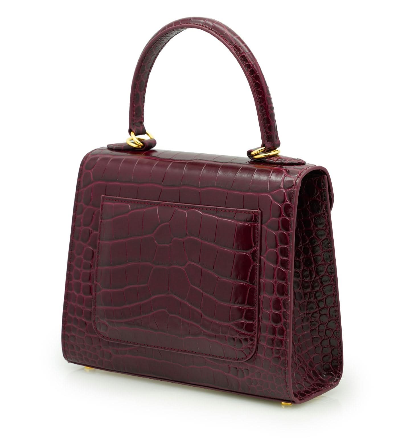 حقيبة يد جلدية منقوش عليها جلد التمساح باللون العنابي للسيدة الأولى
