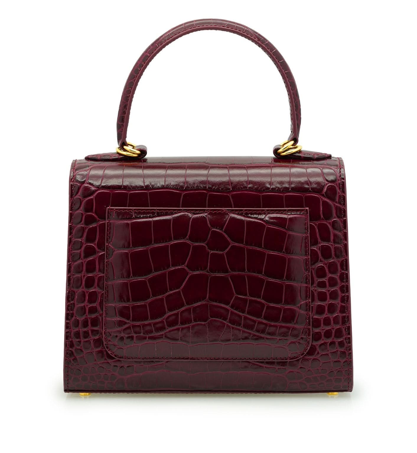 حقيبة يد جلدية منقوش عليها جلد التمساح باللون العنابي للسيدة الأولى