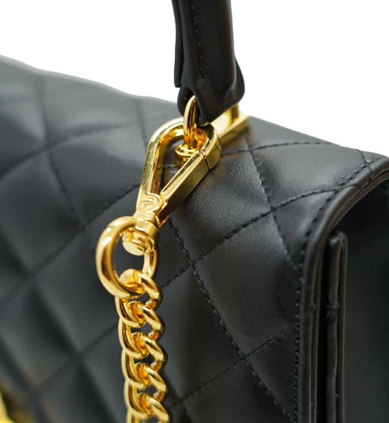 حقيبة أوبرا الجلدية السوداء المبطنة بسلسلة على شكل زهرة ملتوية